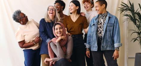 Portrait of cheerful mixed age range multi ethnic women - stock image