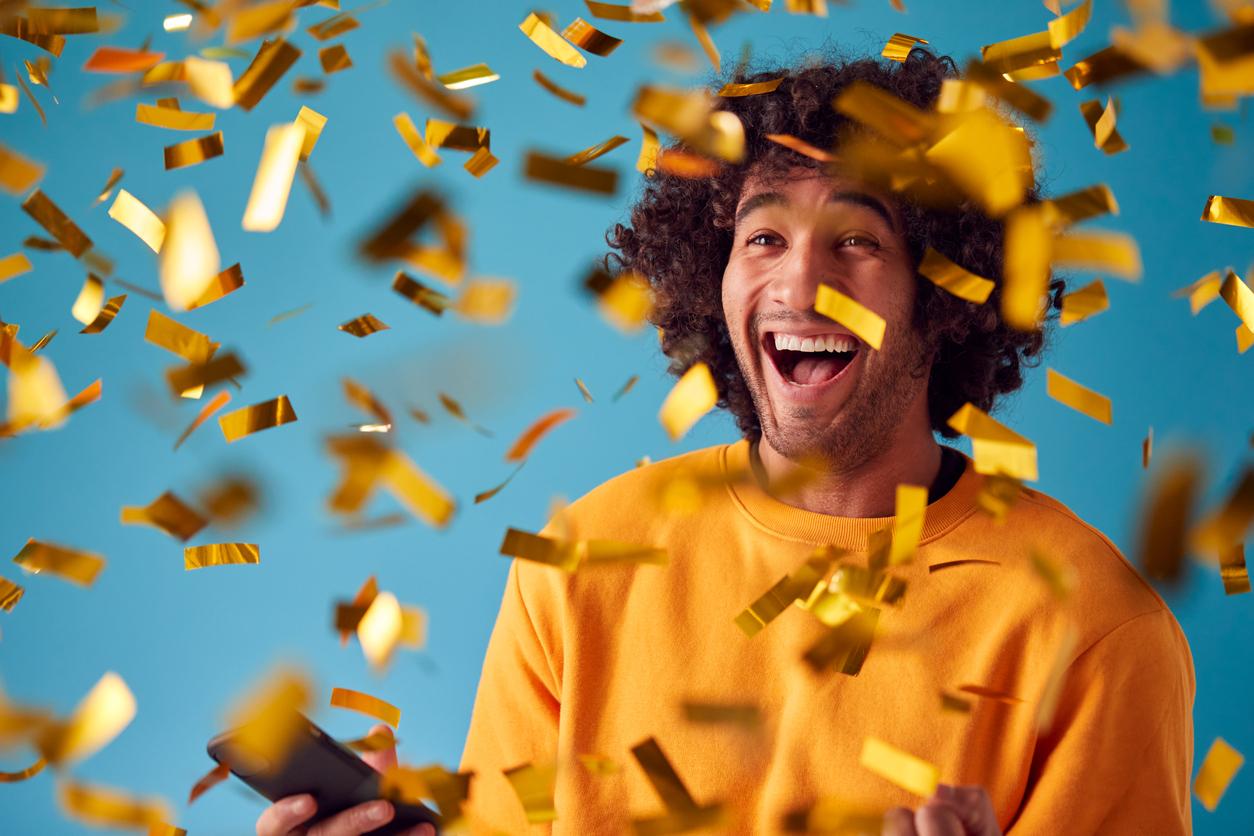 Celebrating Young Man Showered With Gold Confetti